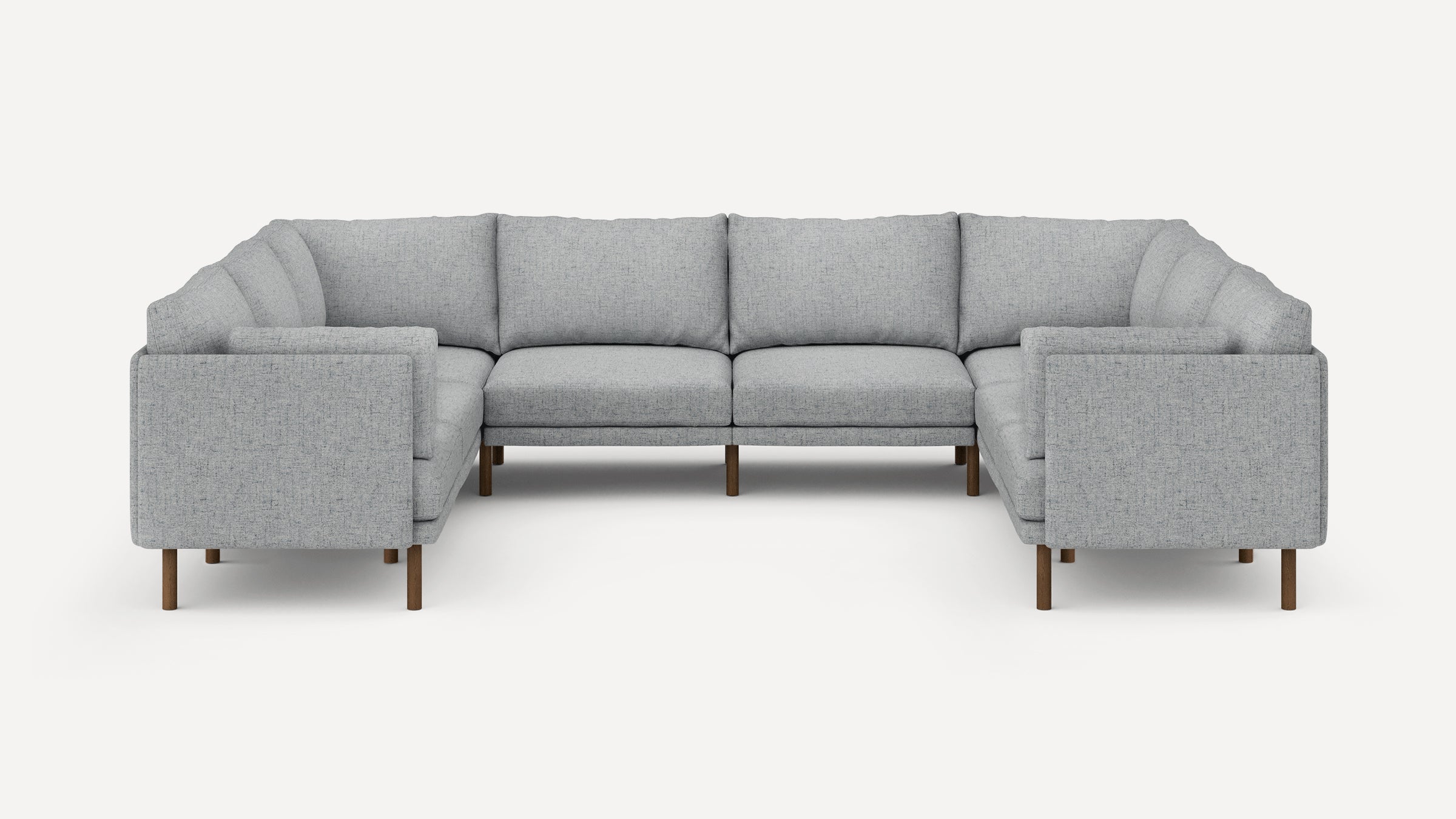 Modern U-shaped sectional sofa in light gray fabric with wooden legs, featuring clean lines and plush cushions.