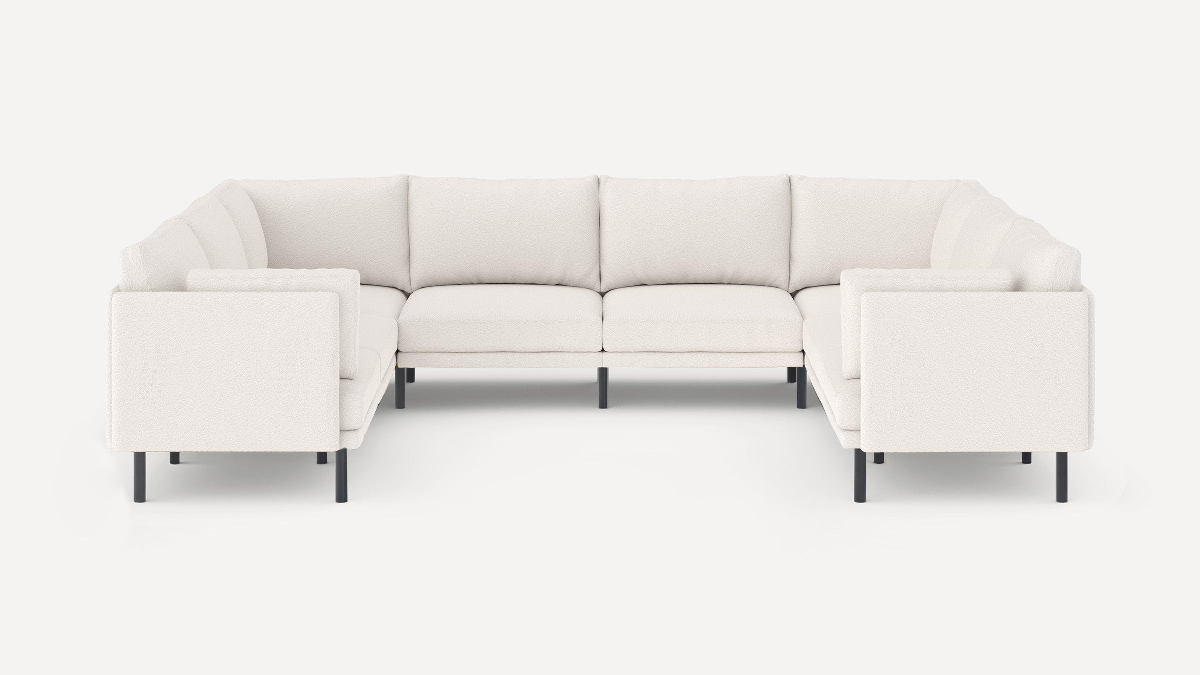 Modern U-shaped sectional sofa with soft white upholstery and black slender legs, featuring plush cushions and clean lines.