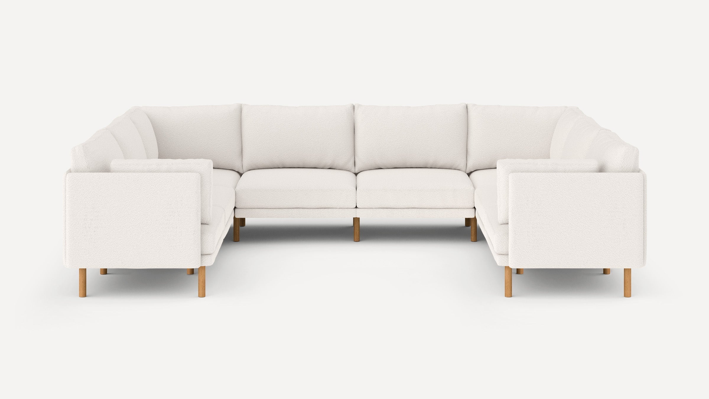 Modern L-shaped sectional sofa with white upholstery and wooden legs, featuring plush cushions and clean, straight armrests.
