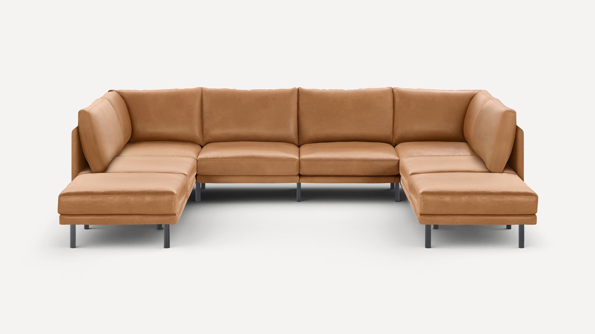 Modern U-shaped sectional sofa in tan leather with clean lines and metal legs on a white background.