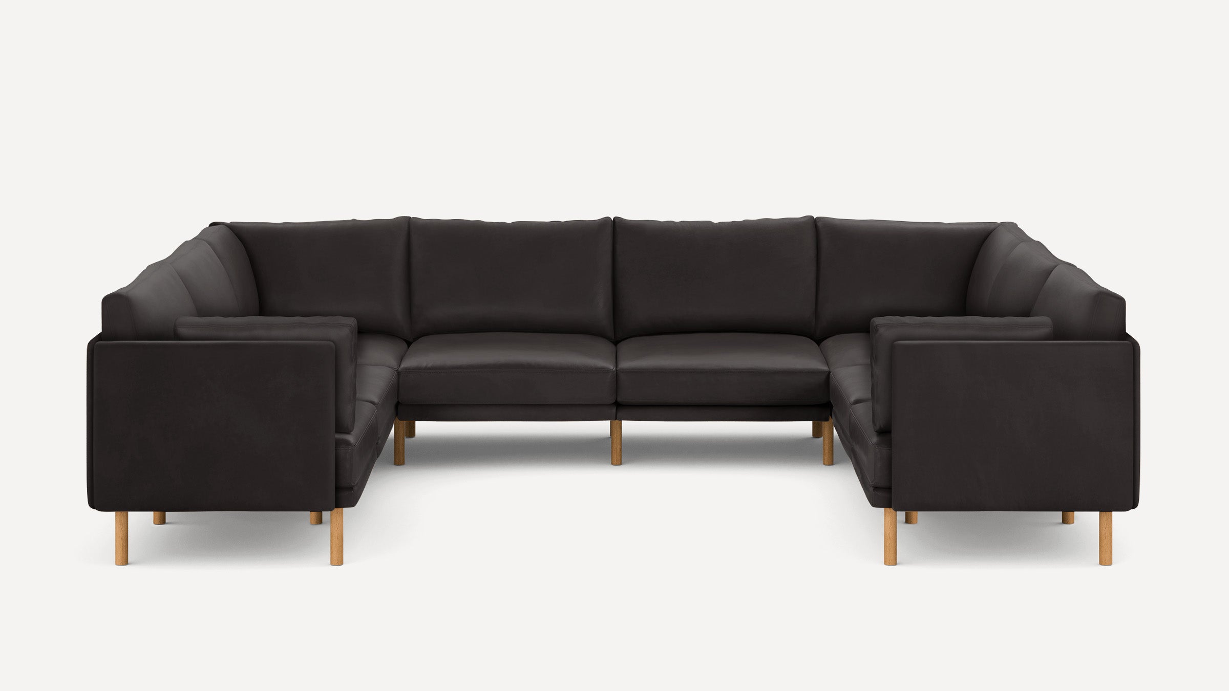 Large modern U-shaped sectional sofa with dark upholstery and wooden legs, featuring clean lines and plush cushions.