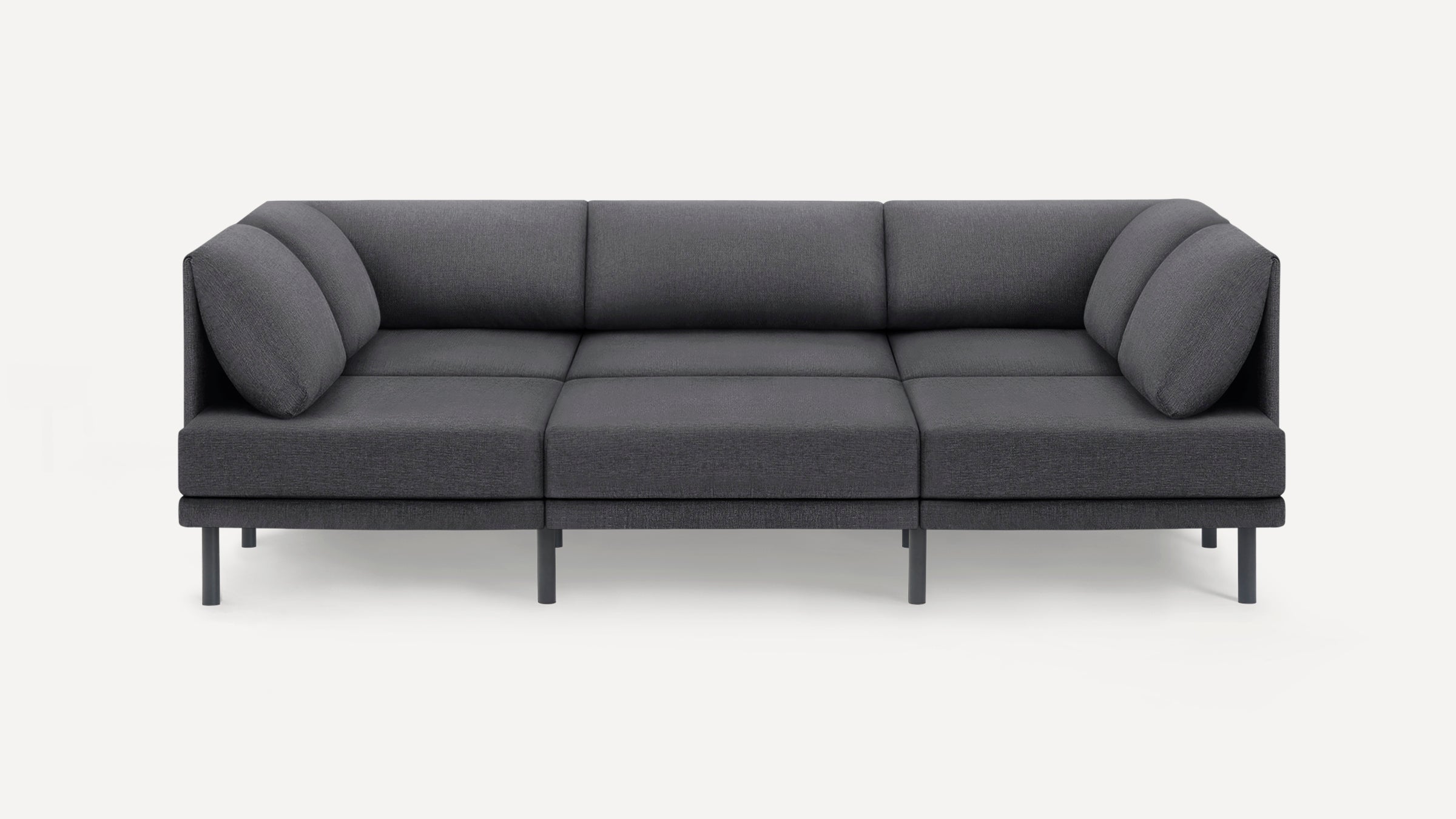Modern dark gray three-seater sofa with cushions, straight arms, and slim black legs, set against a plain white background.