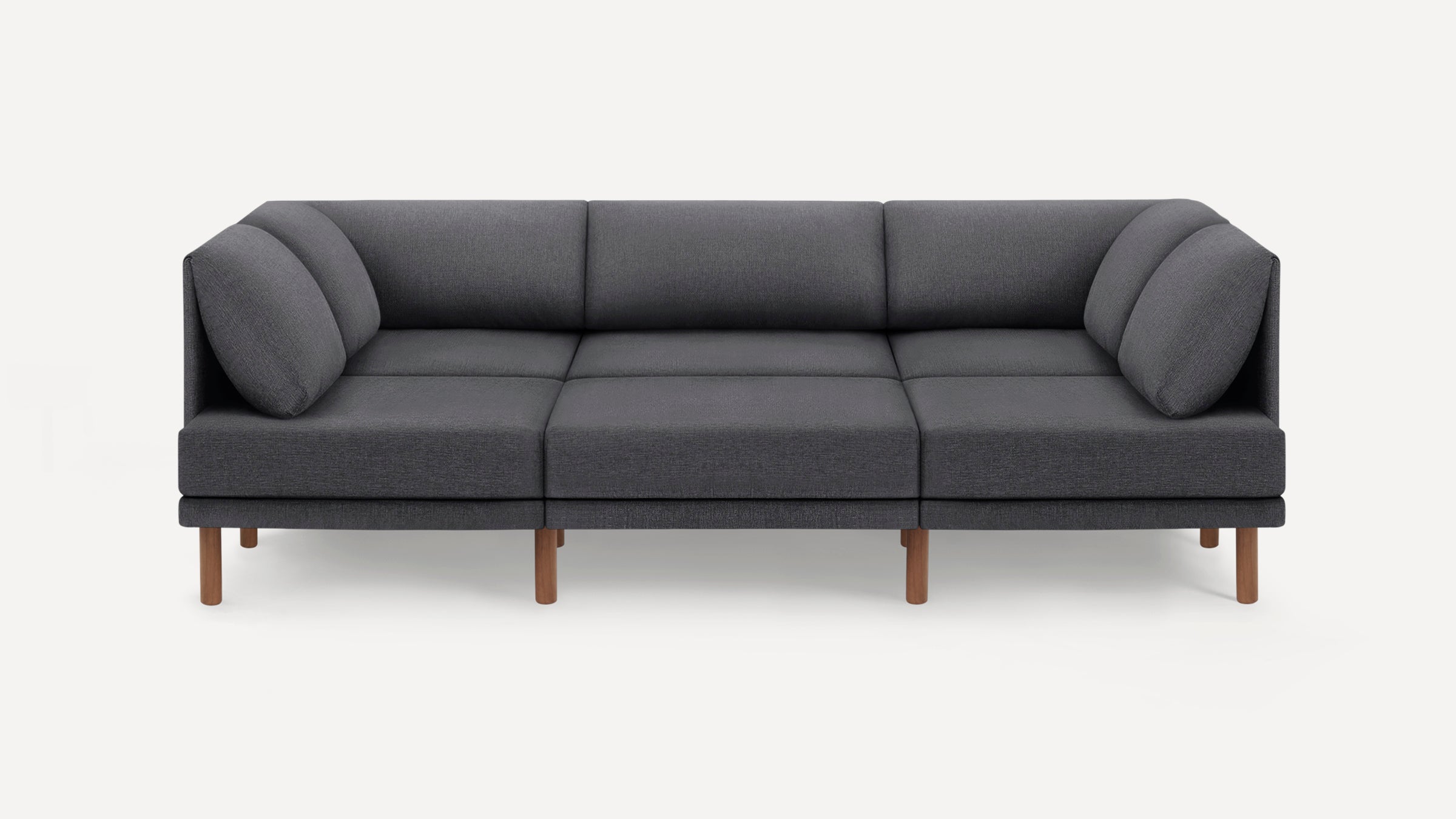 Modern dark gray fabric sofa with clean lines, three seat cushions, angled back cushions, and wooden legs.