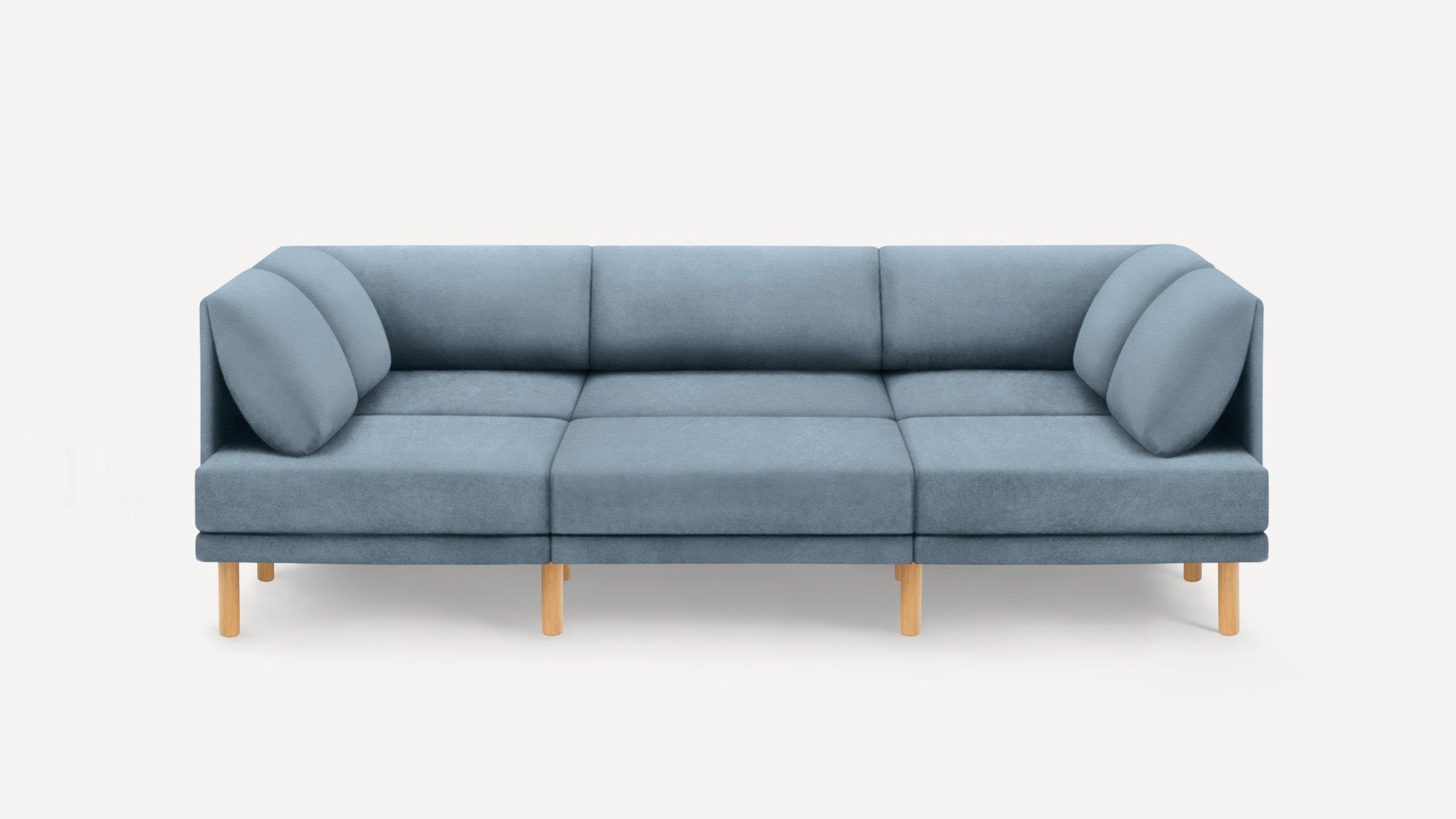 Modern three-seater sofa in muted blue fabric with wooden legs and cushioned armrests on a plain white background.