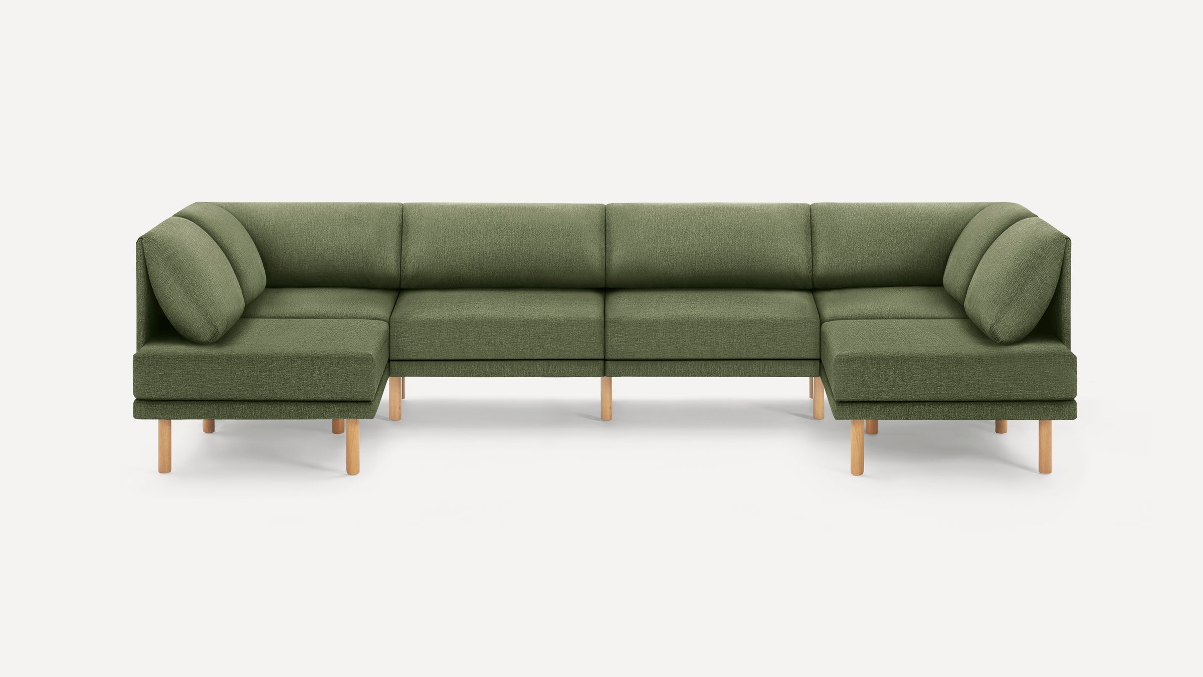 Green fabric U-shaped sectional sofa with wooden legs and cushioned backrests and armrests on a white background.
