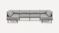 Modern light gray L-shaped sectional sofa with wooden legs and cushioned backrest and armrests.