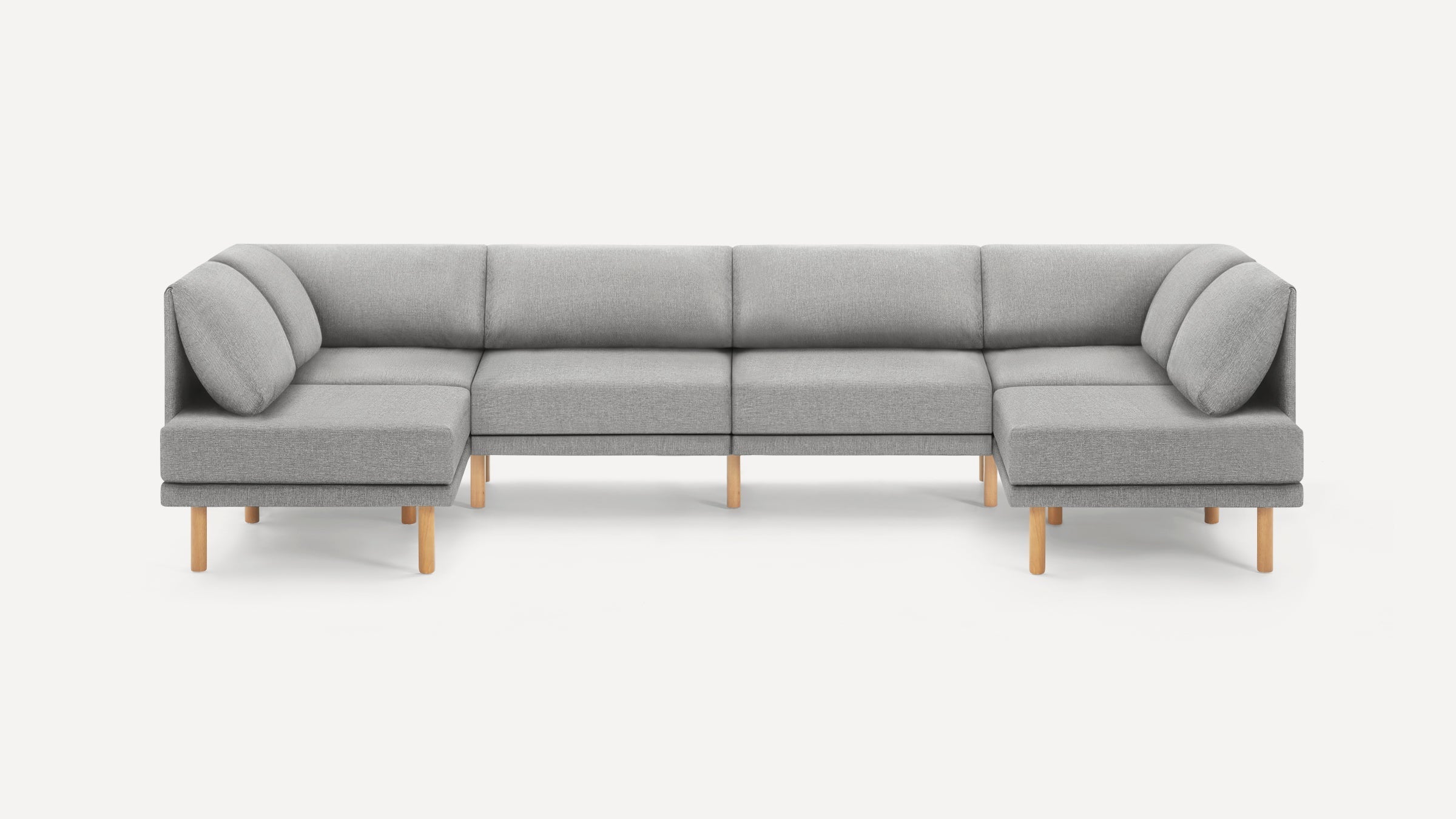 Modern light gray fabric U-shaped sectional sofa with wooden legs and cushioned backrests on a white background.