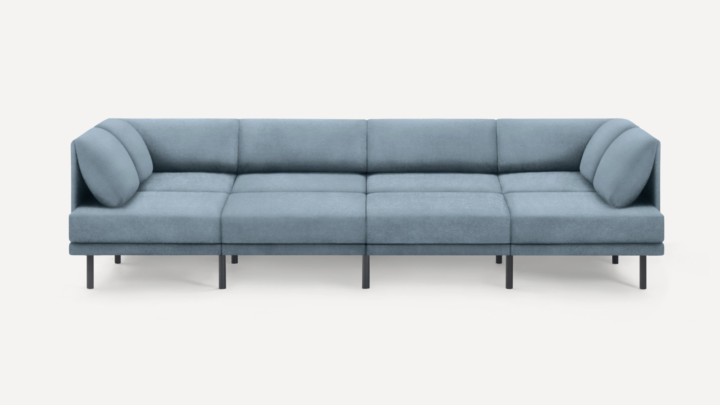 Modern light blue sectional sofa with clean lines, low backrest, cushioned seats, and black metal legs on a white background.