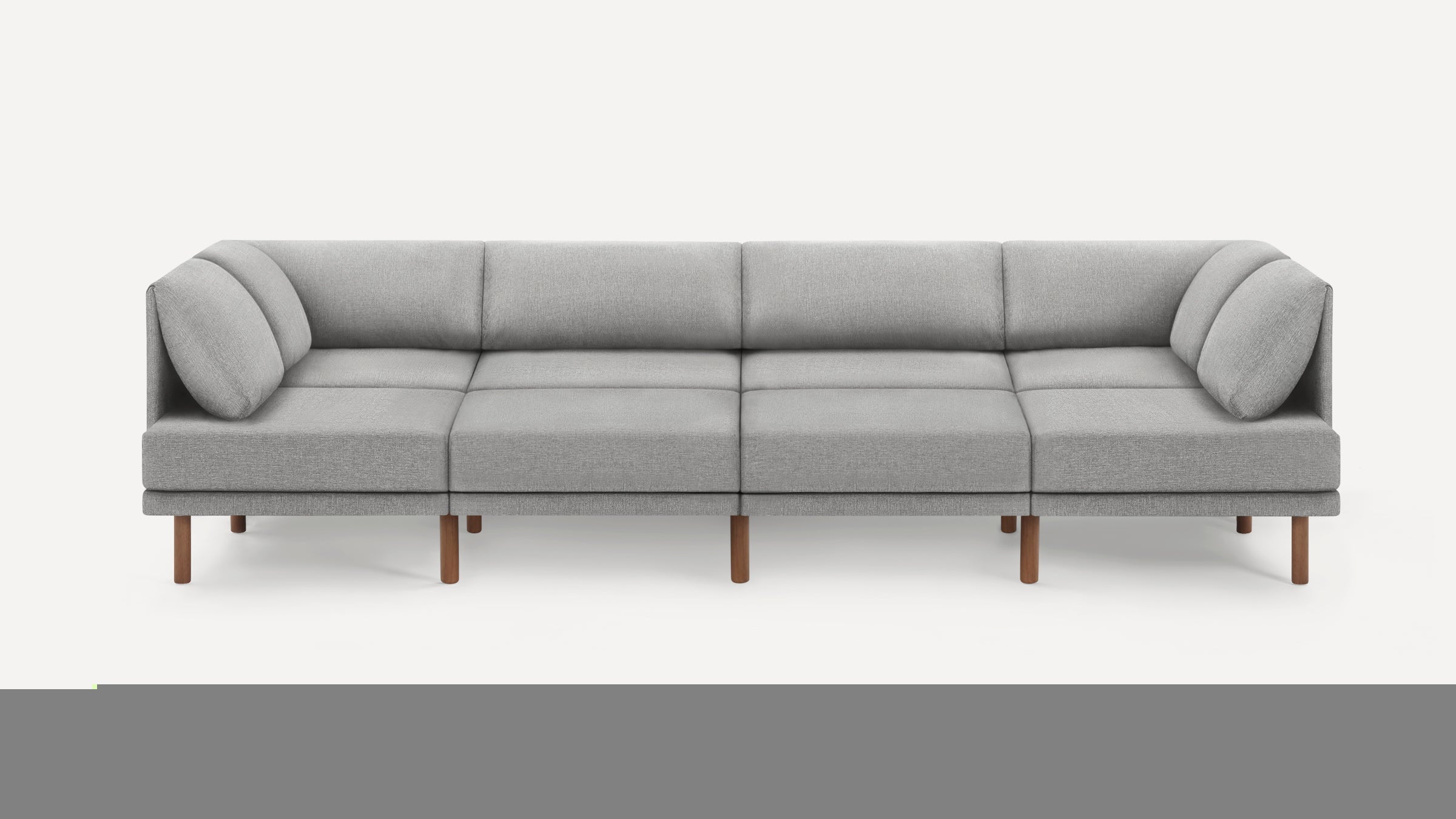 Modern modular gray fabric sofa with wooden legs, featuring clean lines and plush cushions for comfortable seating.