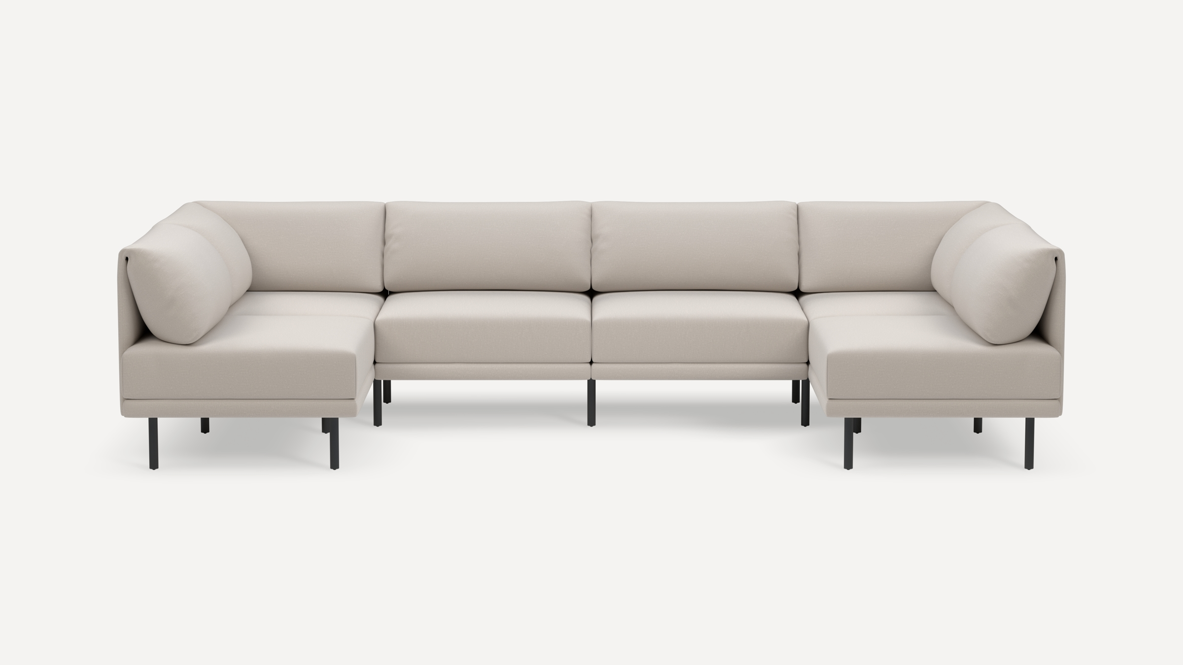 Modern beige sectional sofa with a minimalist design, elevated on slim black metal legs, featuring plush cushions and corner seating.