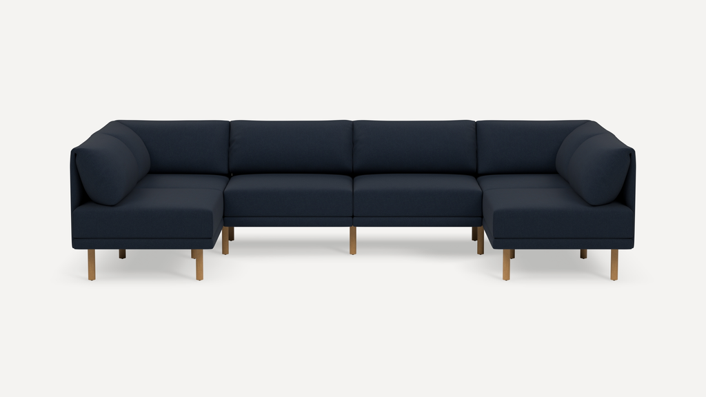 Modern navy blue sectional sofa with wooden legs, featuring clean lines and plush cushions for comfortable seating.