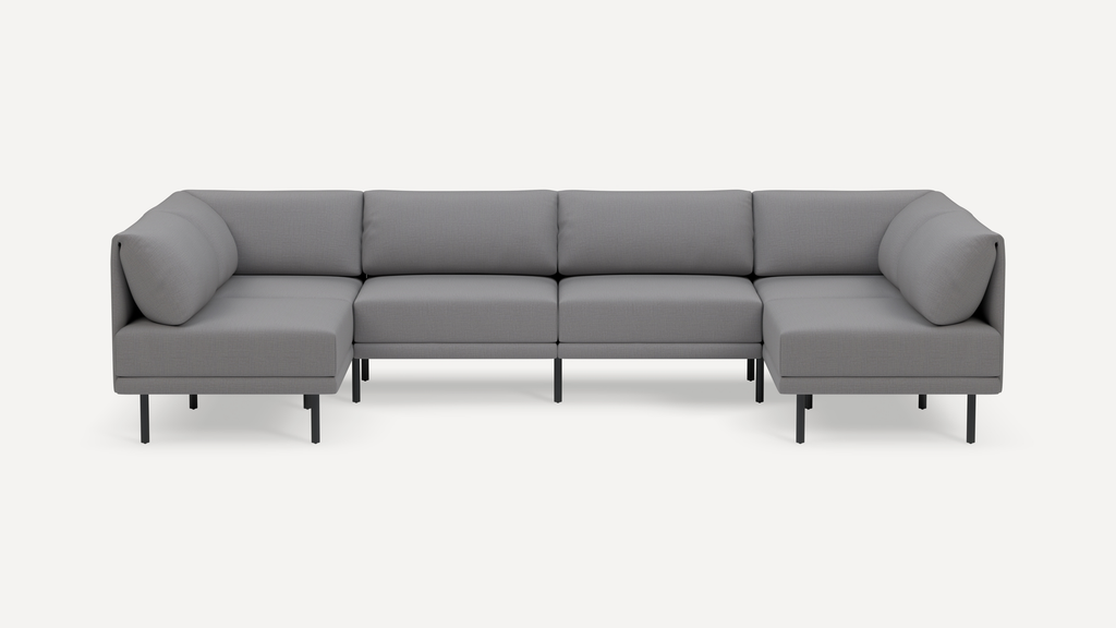 Modern gray fabric U-shaped sectional sofa with low back cushions and black metal legs on a white background.