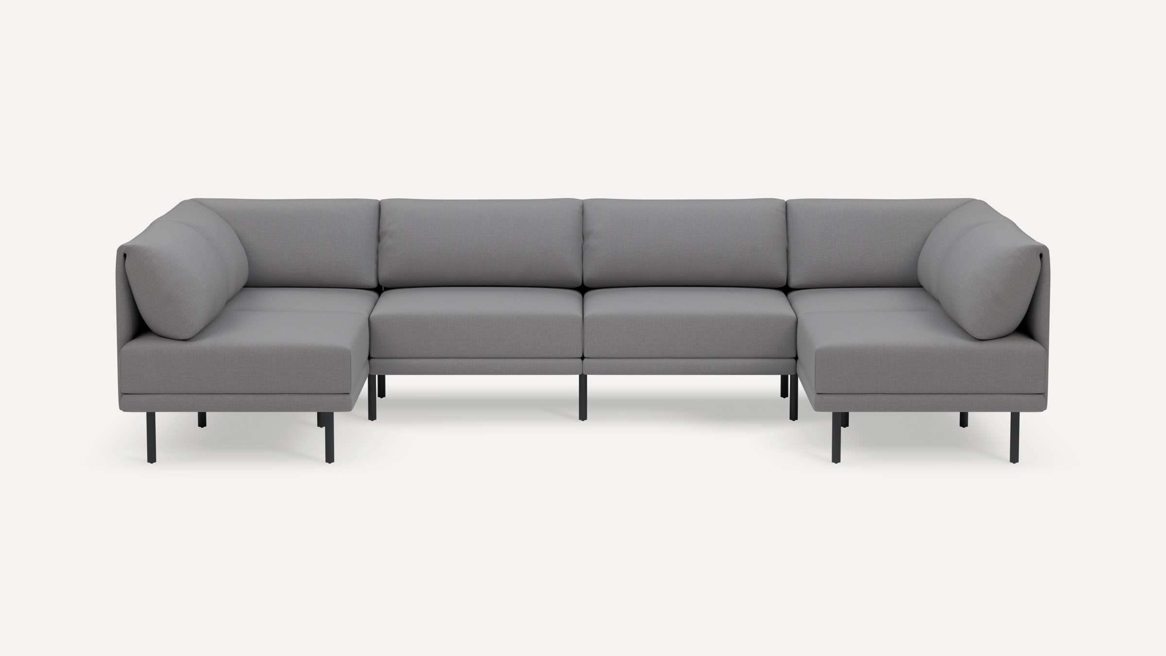 Modern gray fabric U-shaped sectional sofa with low back cushions and black metal legs on a white background.