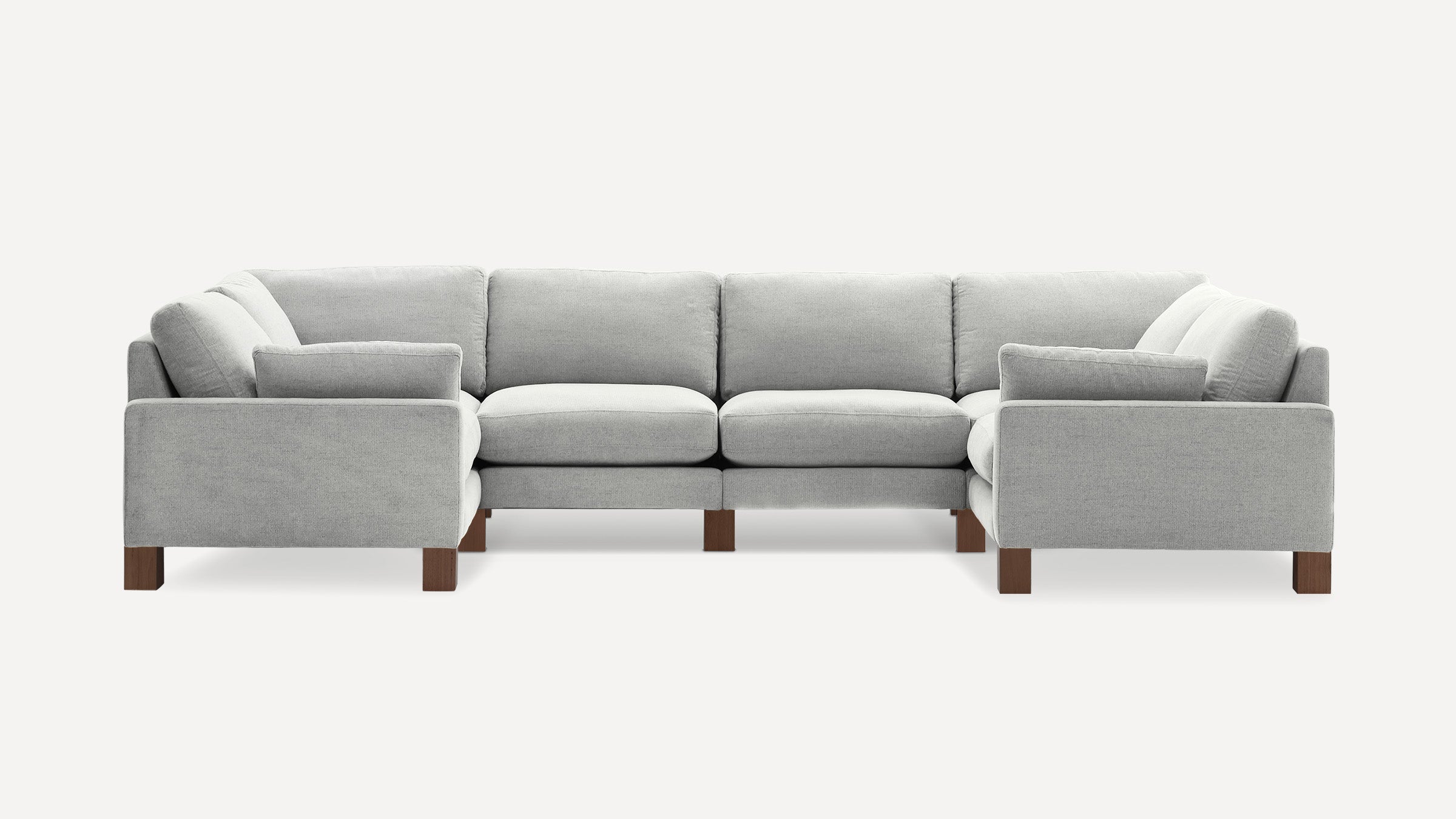 Light gray fabric U-shaped sectional sofa with plush cushions and wooden block legs on a white background.