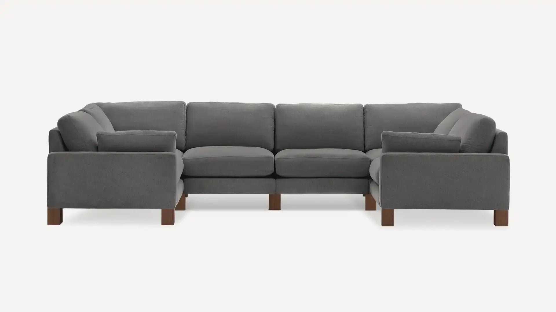 modern l - shaped sectional sofa with dark gray fabric upholstery, tapered wooden legs, and clean lines on a white background