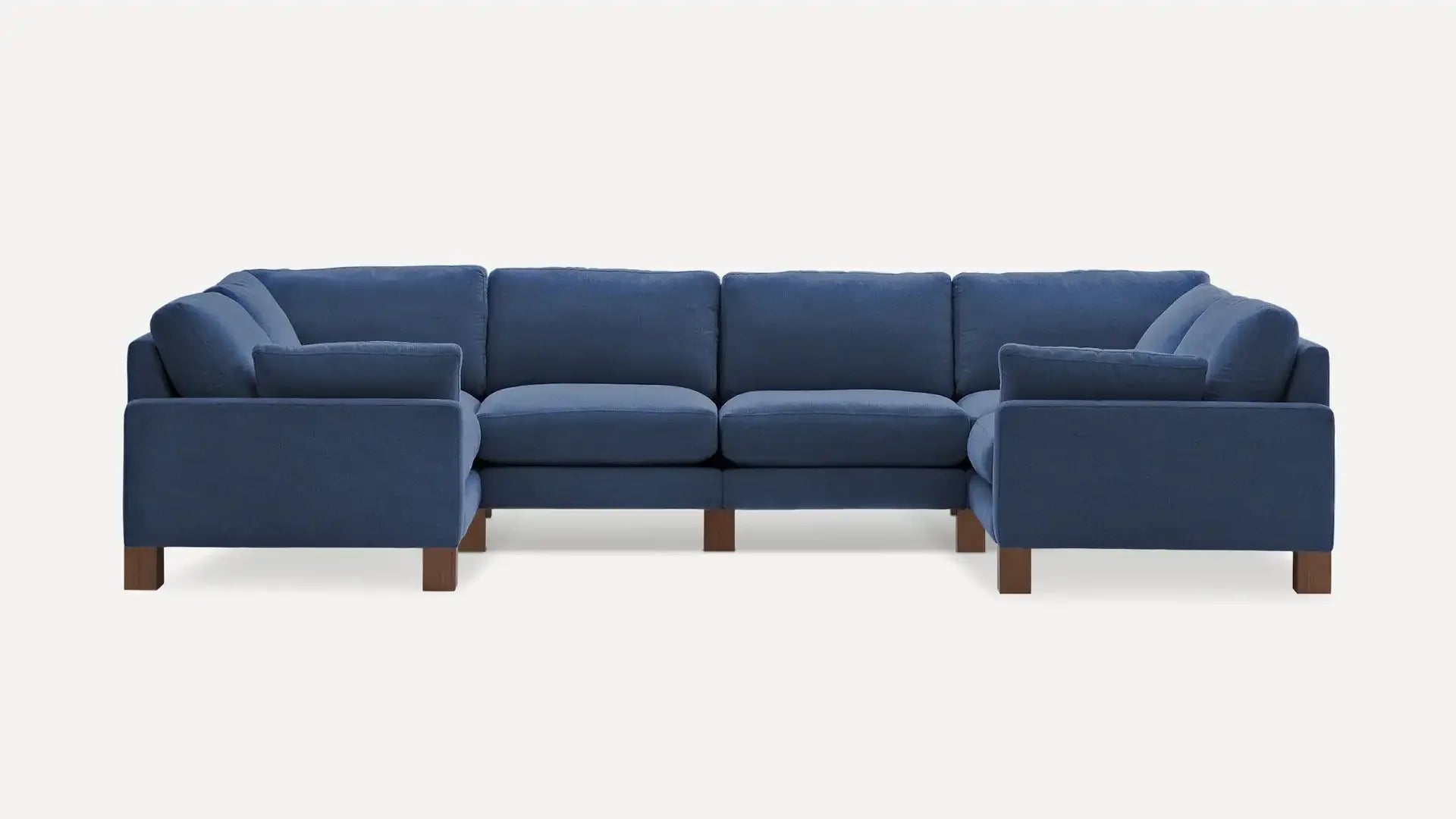 modern blue sectional sofa with wooden legs and pillows