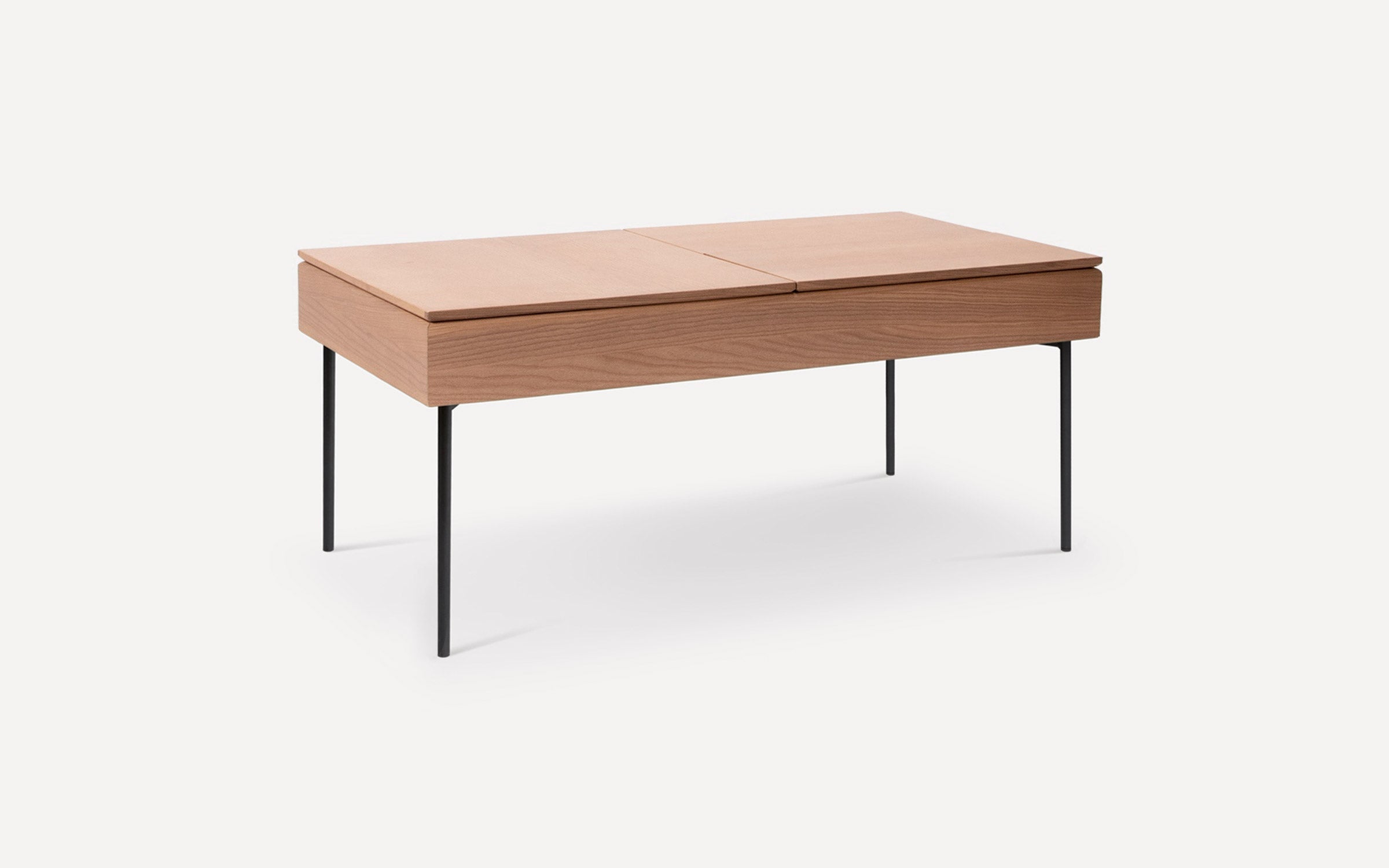 Rectangular wooden coffee table with a split top, supported by four slender black metal legs, minimalist design.
