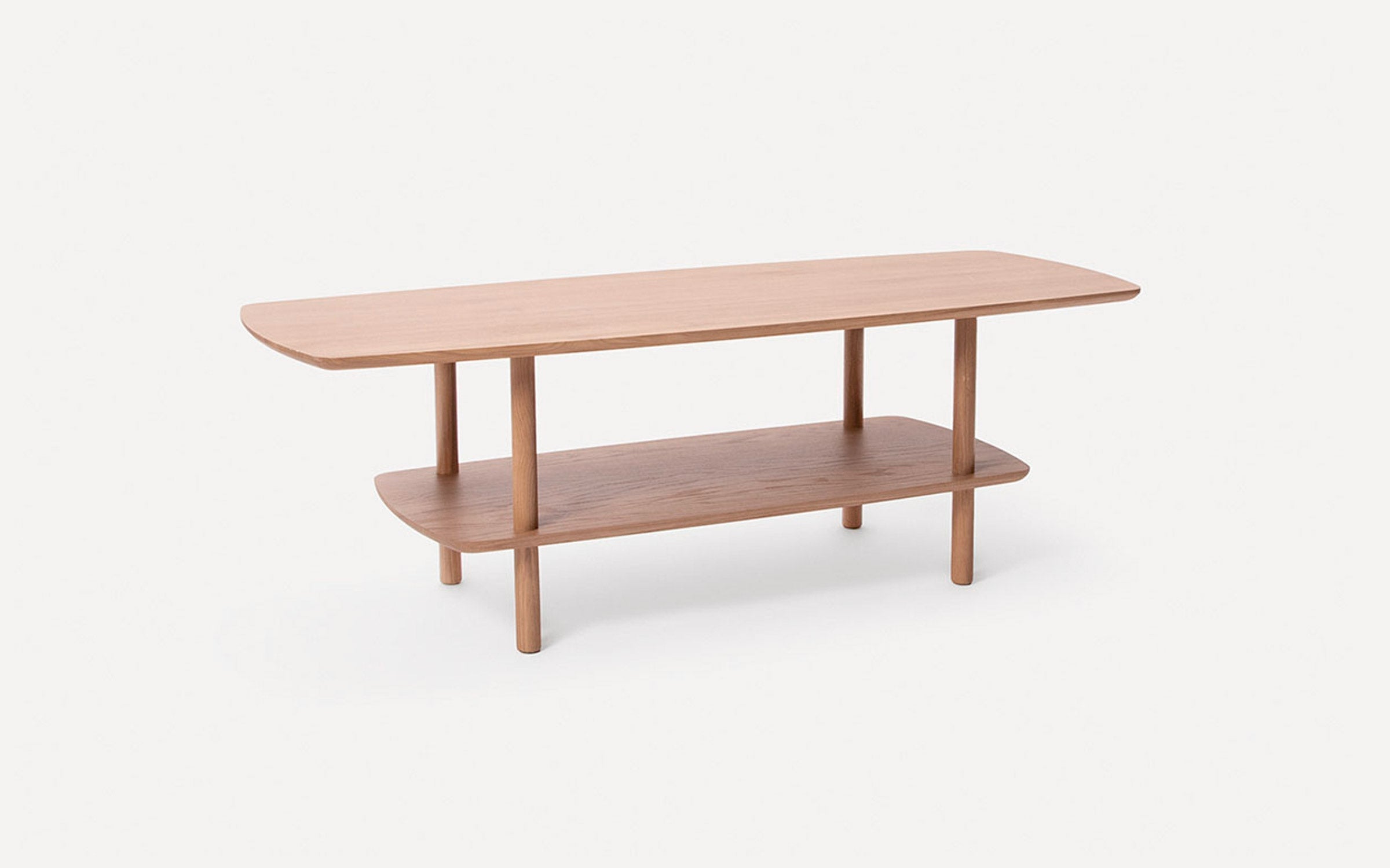 Light wood rectangular coffee table with rounded edges and a lower shelf, supported by four cylindrical legs.