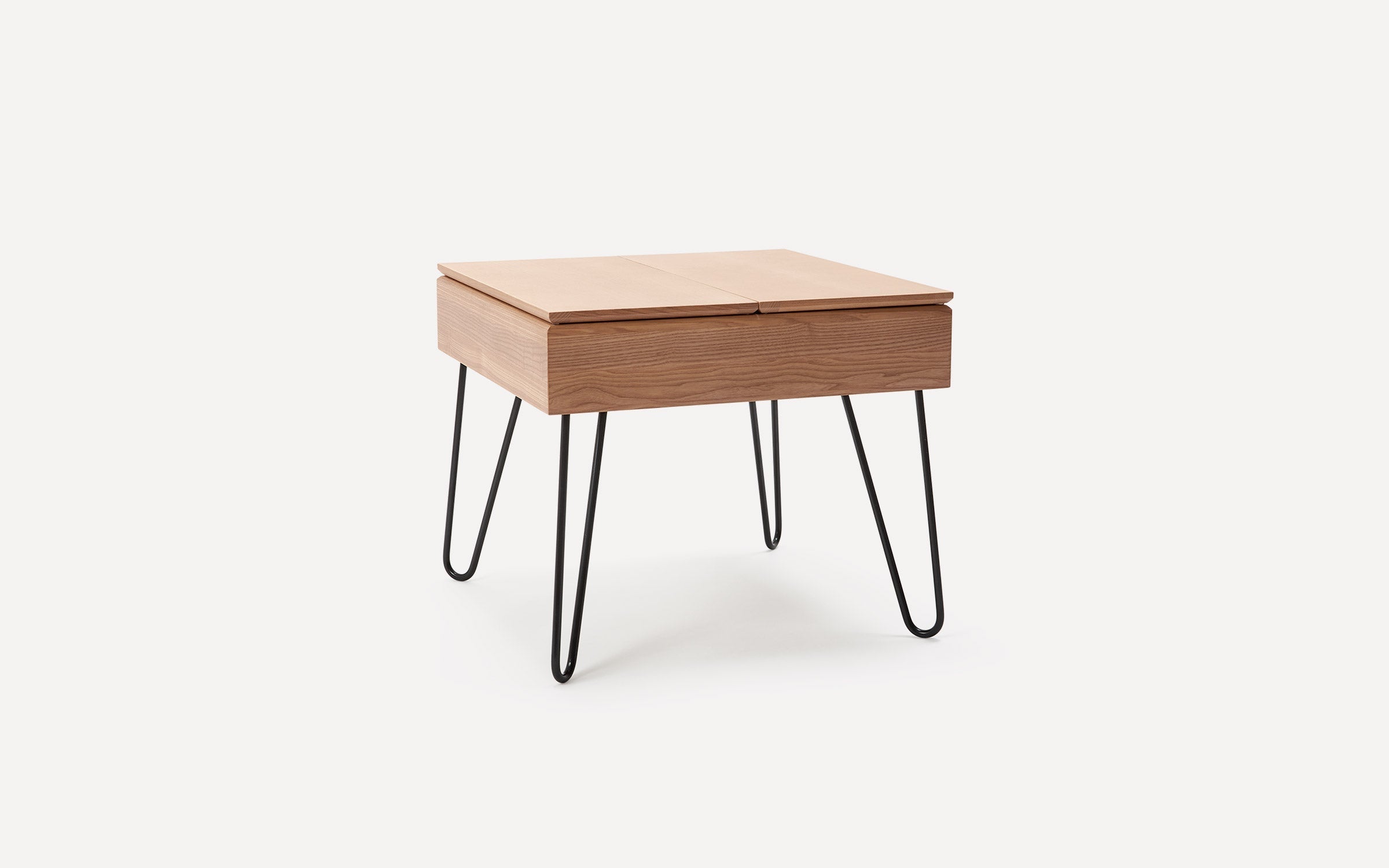 Square wooden side table with light brown top and drawer, supported by four black metal hairpin legs.