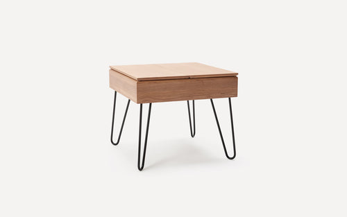 Square wooden side table with light brown top and drawer, supported by four black metal hairpin legs.