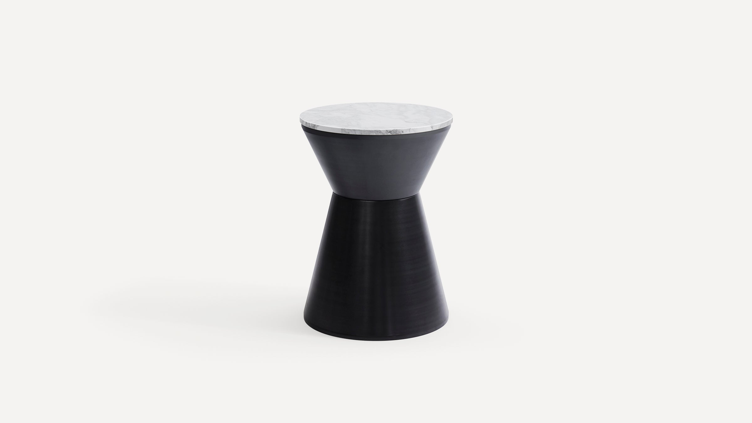 Modern black hourglass-shaped side table with a round white marble top, set against a plain white background.
