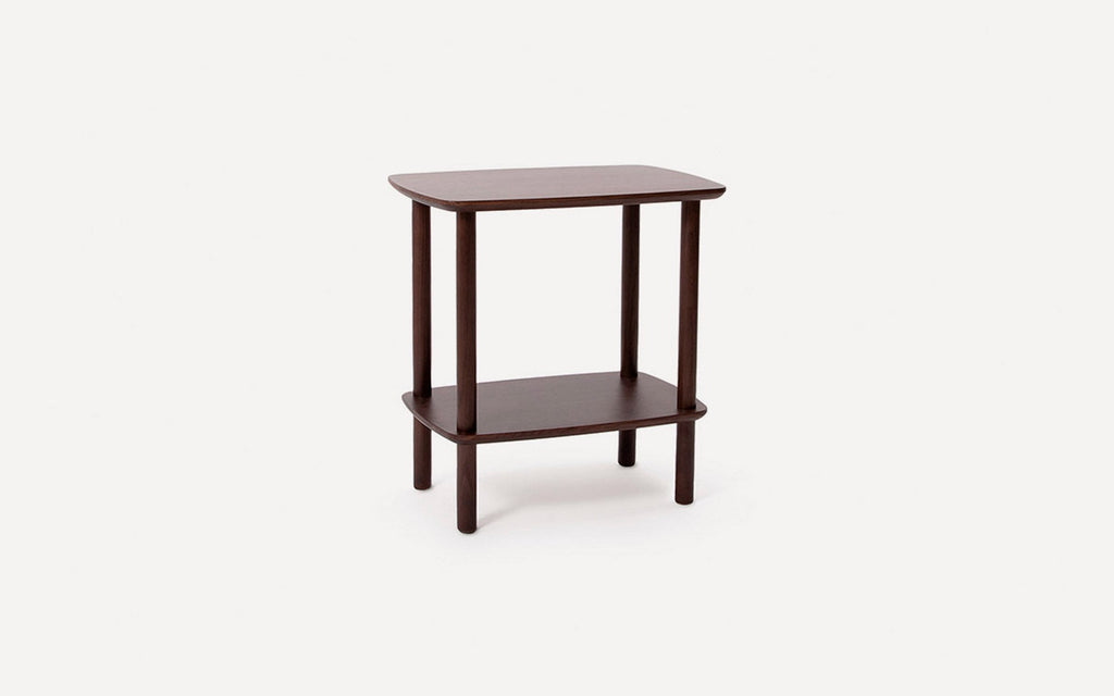 Dark brown wooden side table with square top and lower shelf, supported by four cylindrical legs.