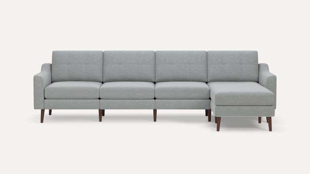 Modern light gray sectional sofa with tufted back cushions, wooden legs, and a right-side chaise lounge.