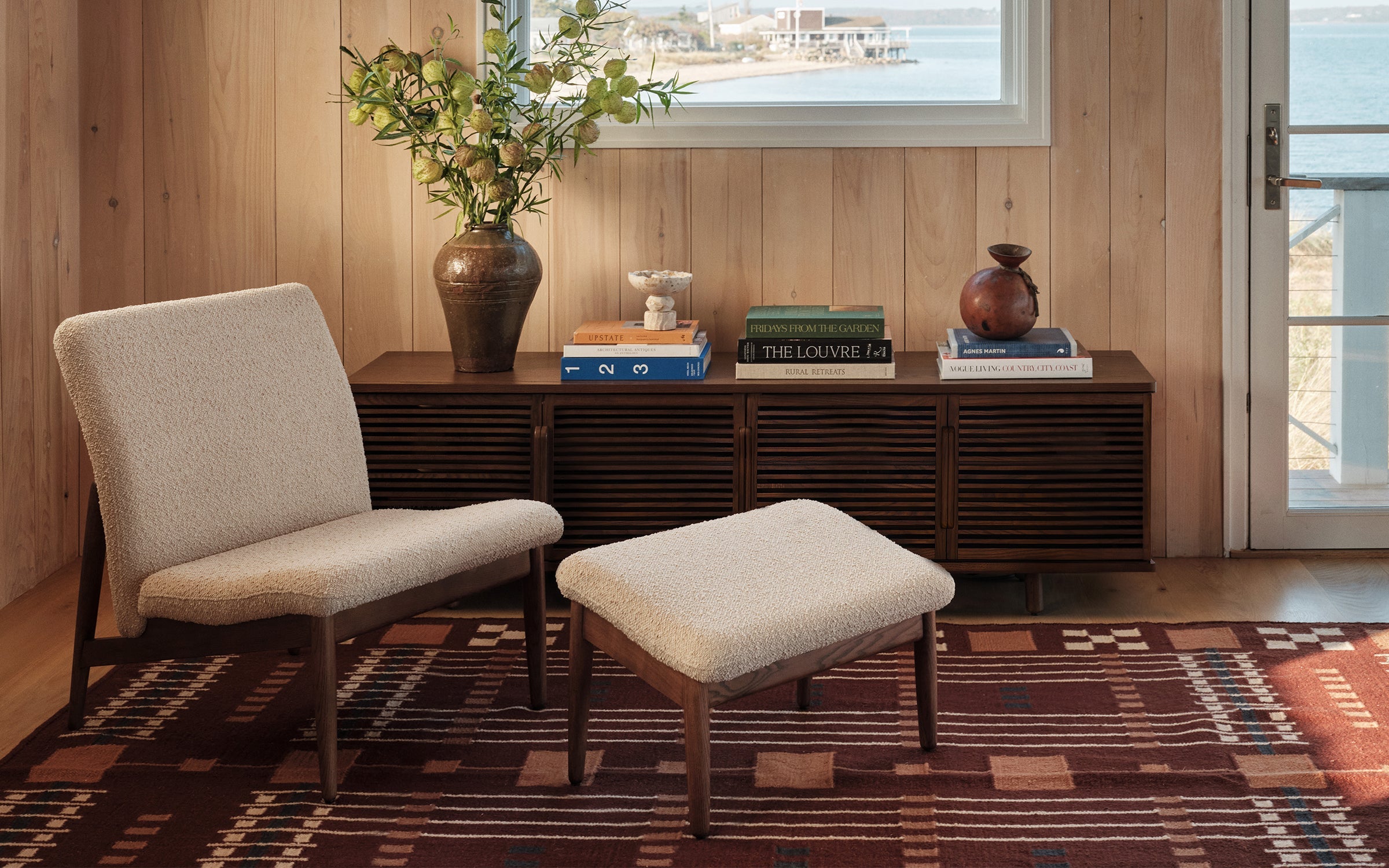 a living room with a wooden wall and a large window