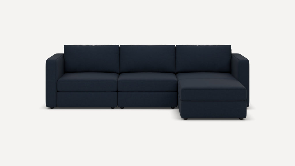 Dark navy blue three-seat sectional sofa with chaise lounge on the right side, featuring clean lines and plush cushions.