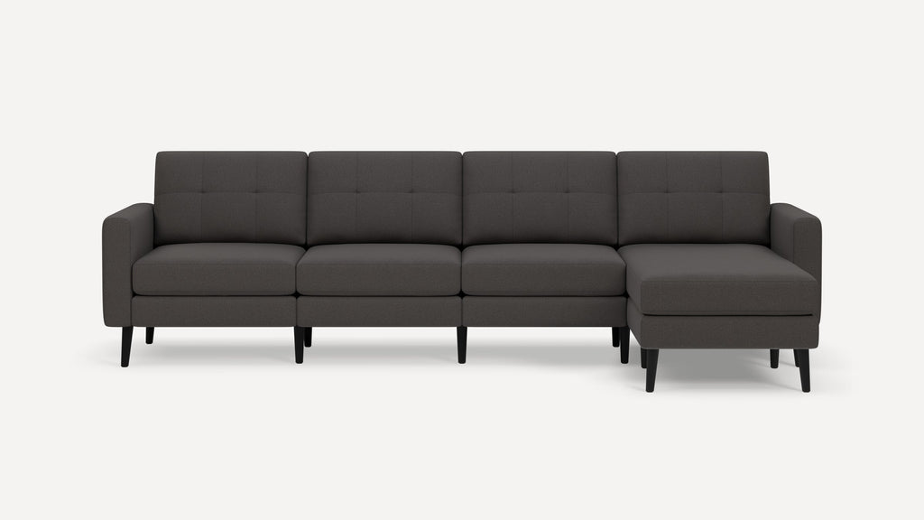 Dark gray modern sectional sofa with tufted back cushions, straight arms, and black tapered wooden legs.