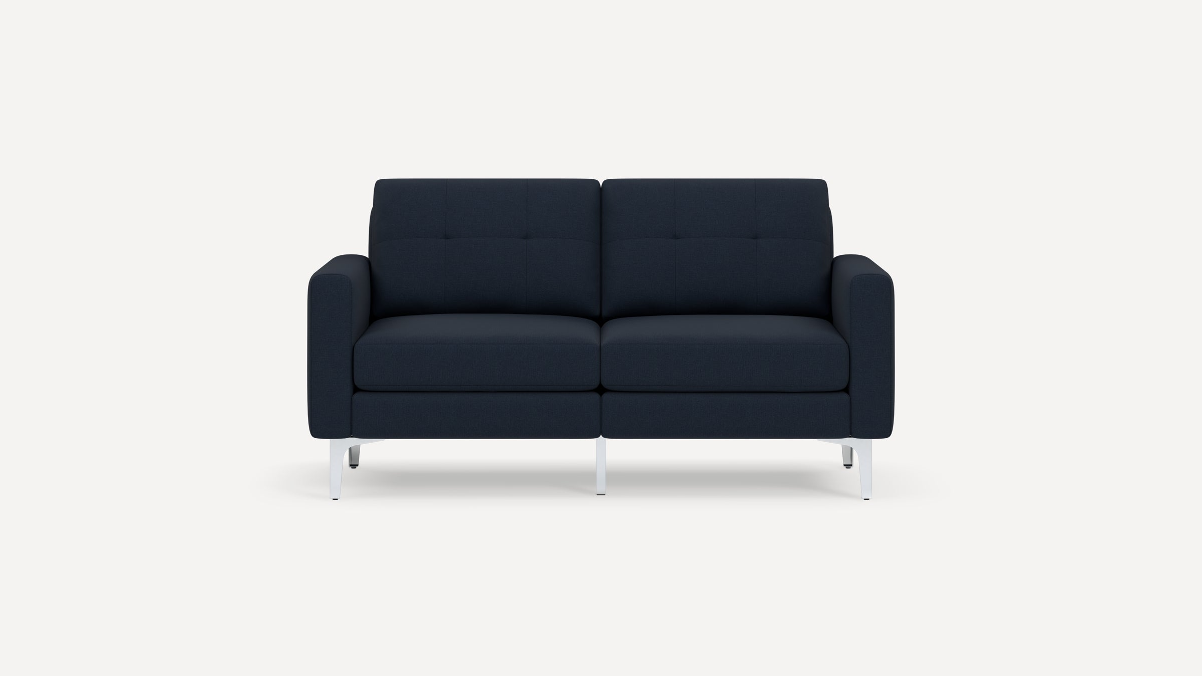 Modern two-seater sofa with dark navy blue upholstery, tufted back cushions, and sleek silver metal legs against a plain white background.