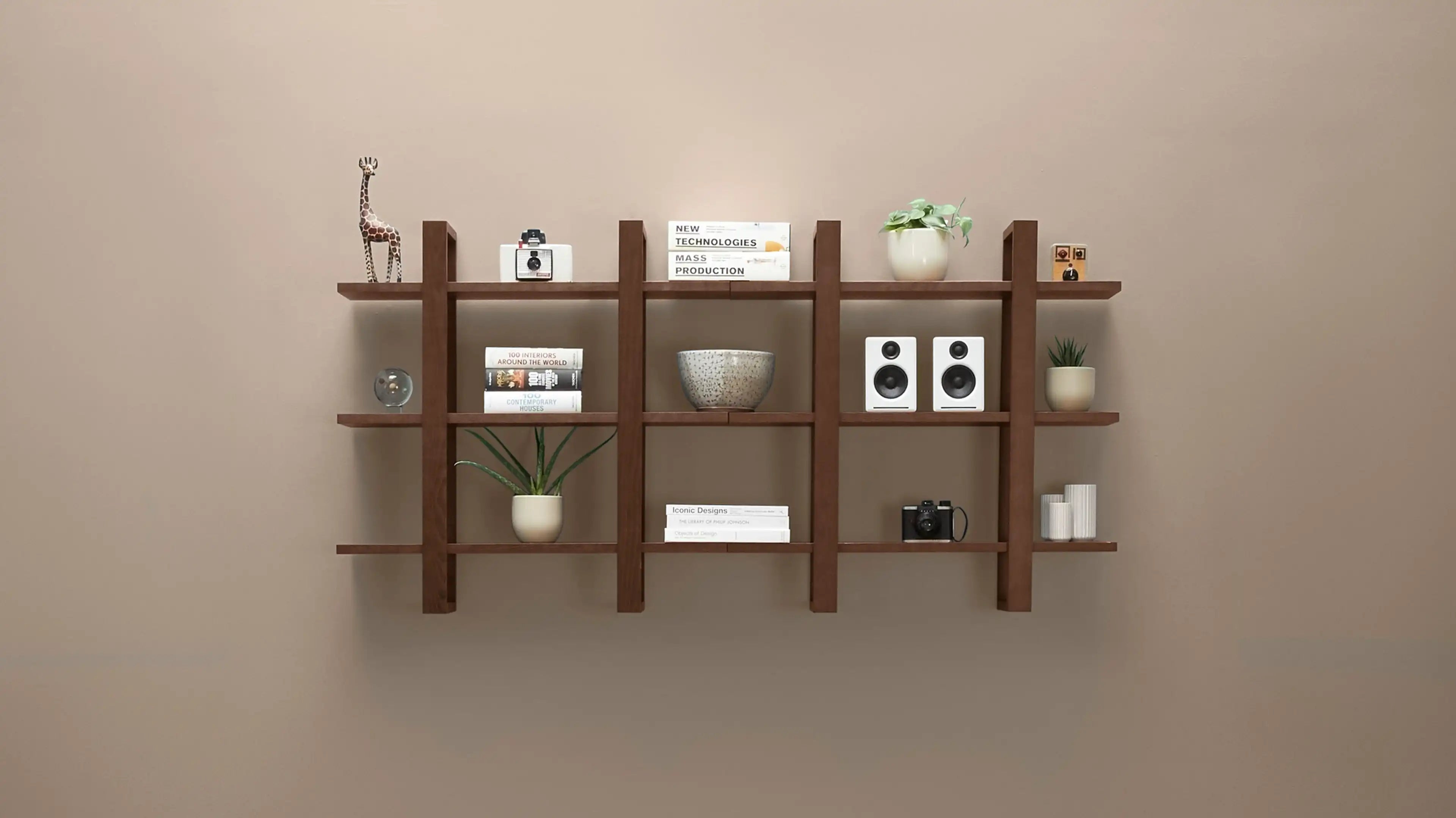Wall-mounted wooden shelf with vertical slats, holding books, plants, speakers, cameras, decorative bowls, and small ornaments.