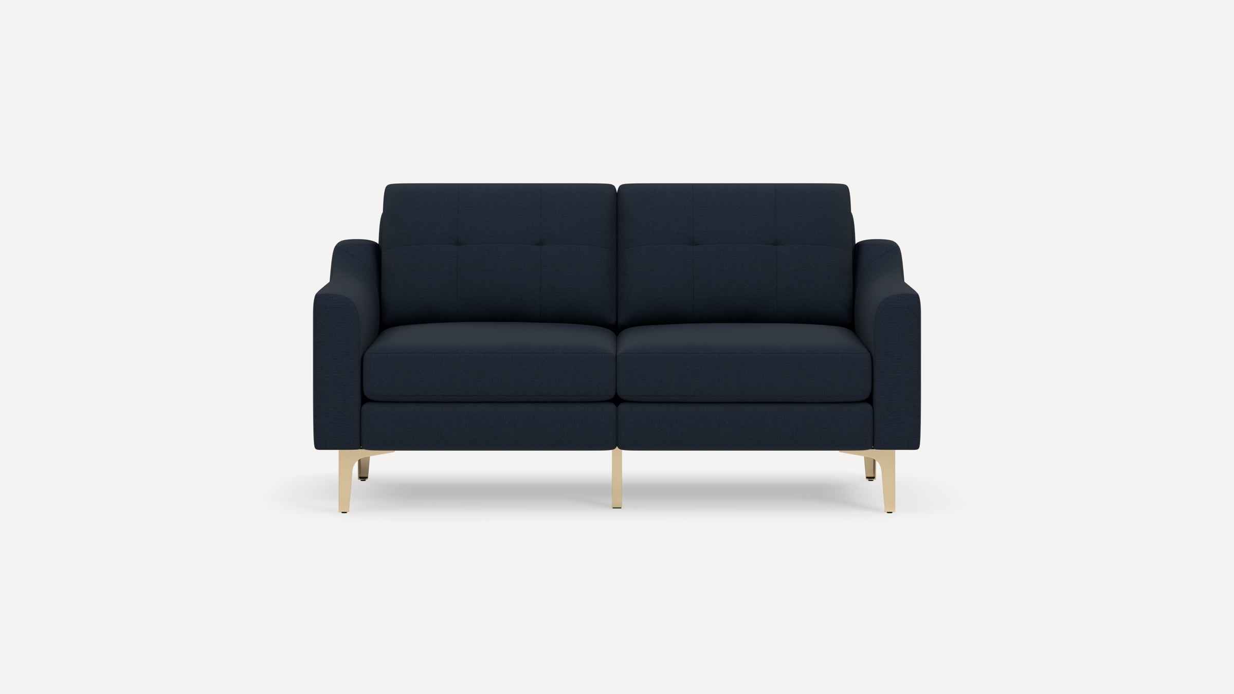Modern navy blue fabric sofa with tufted back cushions and gold metal legs, shown against a white background.