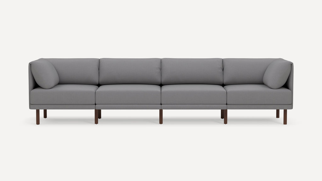 Gray modern sectional sofa with wooden legs, featuring four seat cushions and four back cushions on a plain white background.