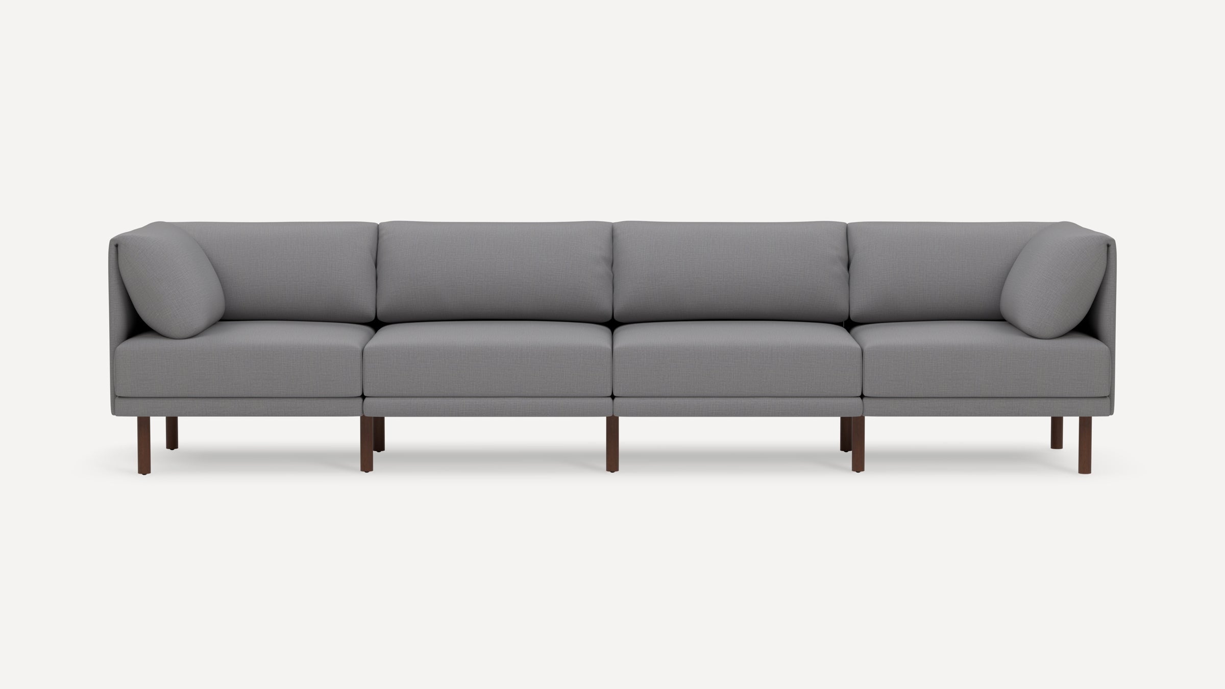 Gray modern sectional sofa with wooden legs, featuring four seat cushions and four back cushions on a plain white background.