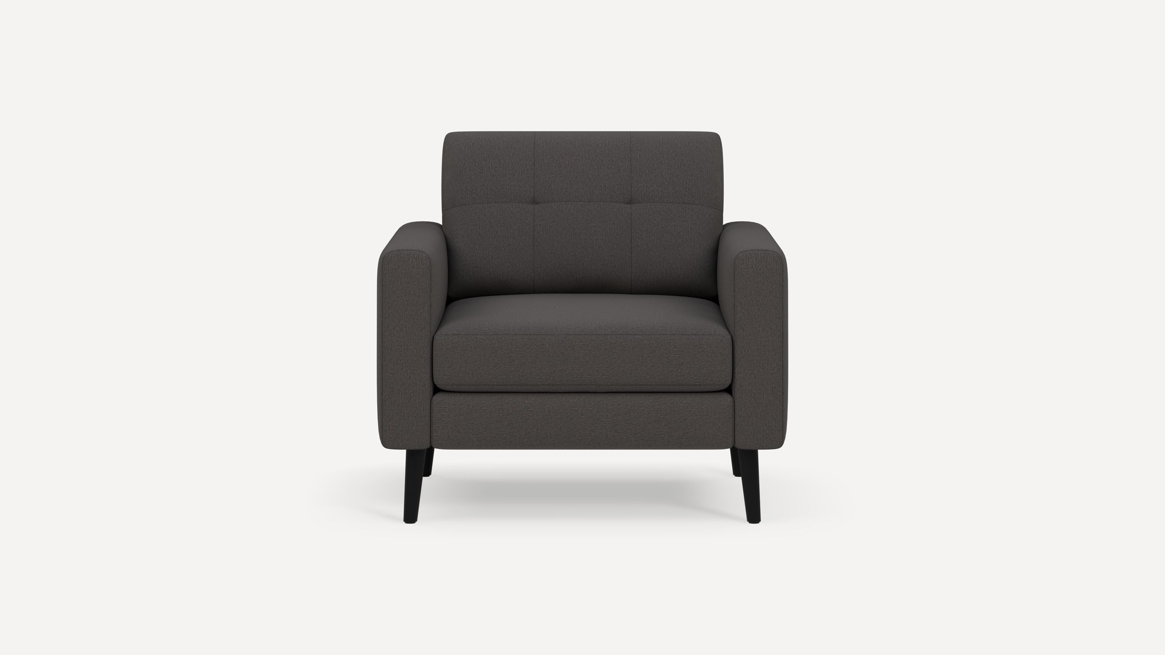 Front view of a modern dark gray fabric armchair with cushioned seat, button-tufted backrest, and black tapered legs on white background.