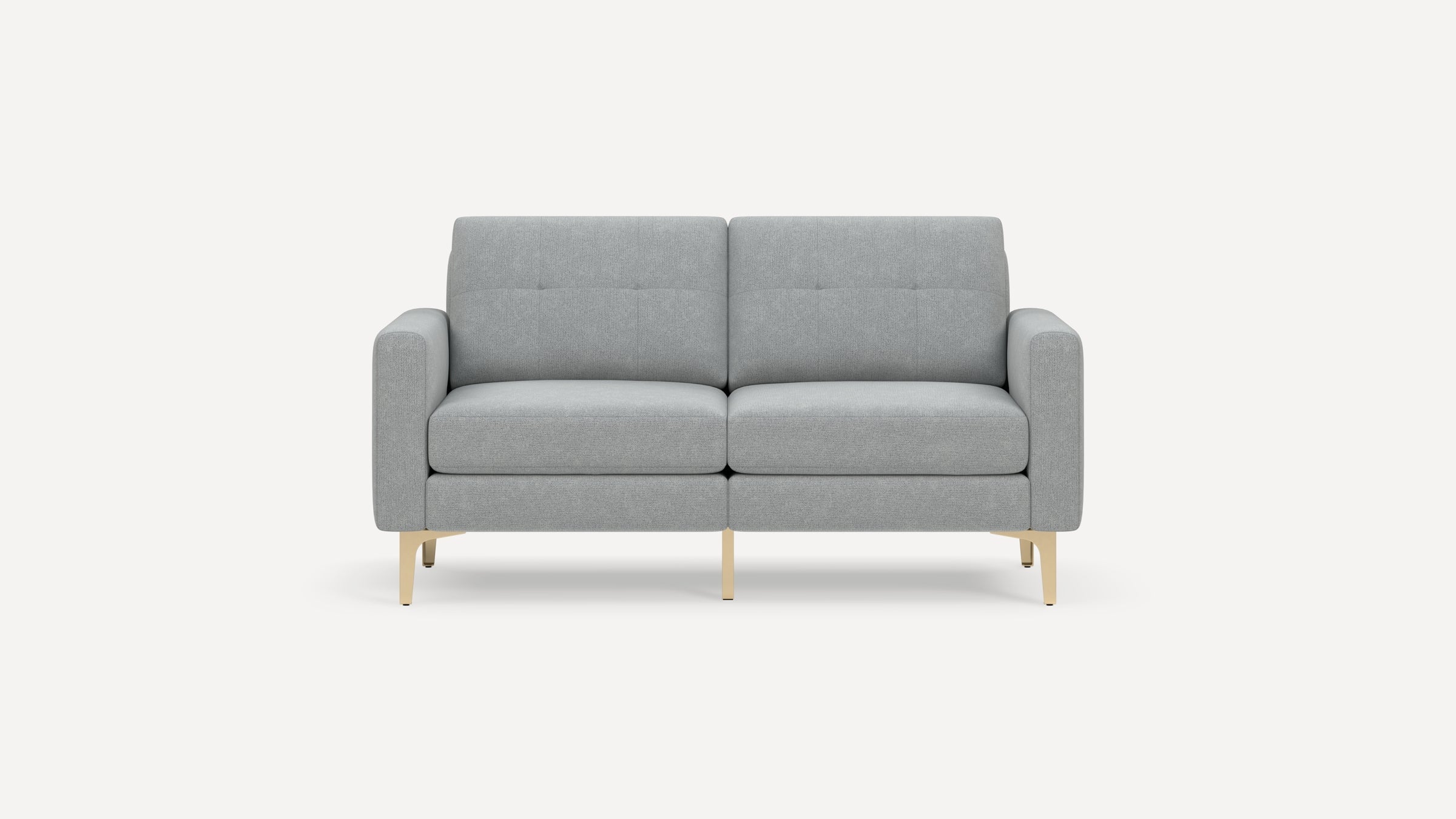 Modern light gray two-seater sofa with clean lines, tufted back cushions, padded armrests, and light wooden legs on a white background.