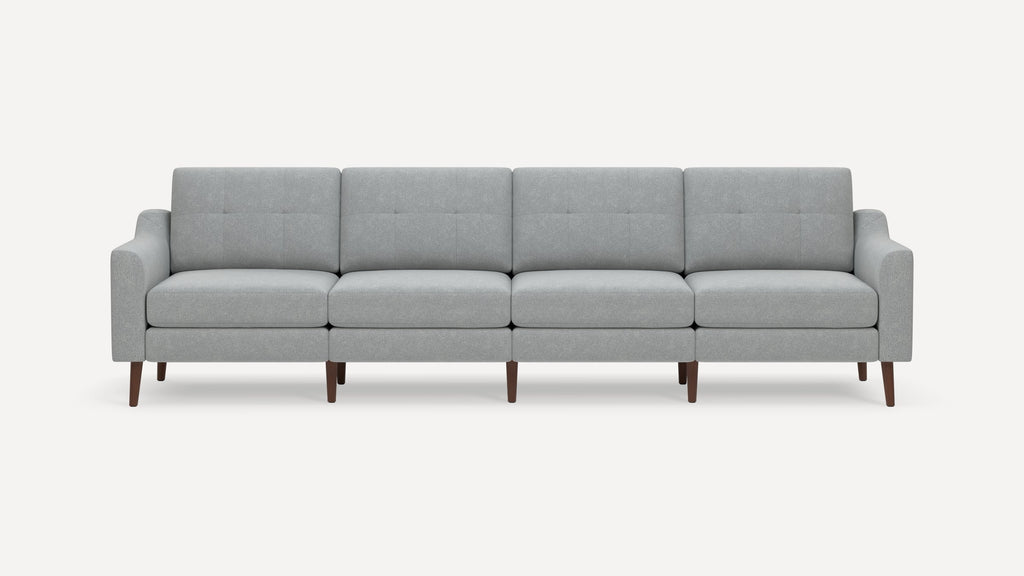 Modern light gray fabric sofa with four cushioned seats, square button-tufted backs, and wooden tapered legs.