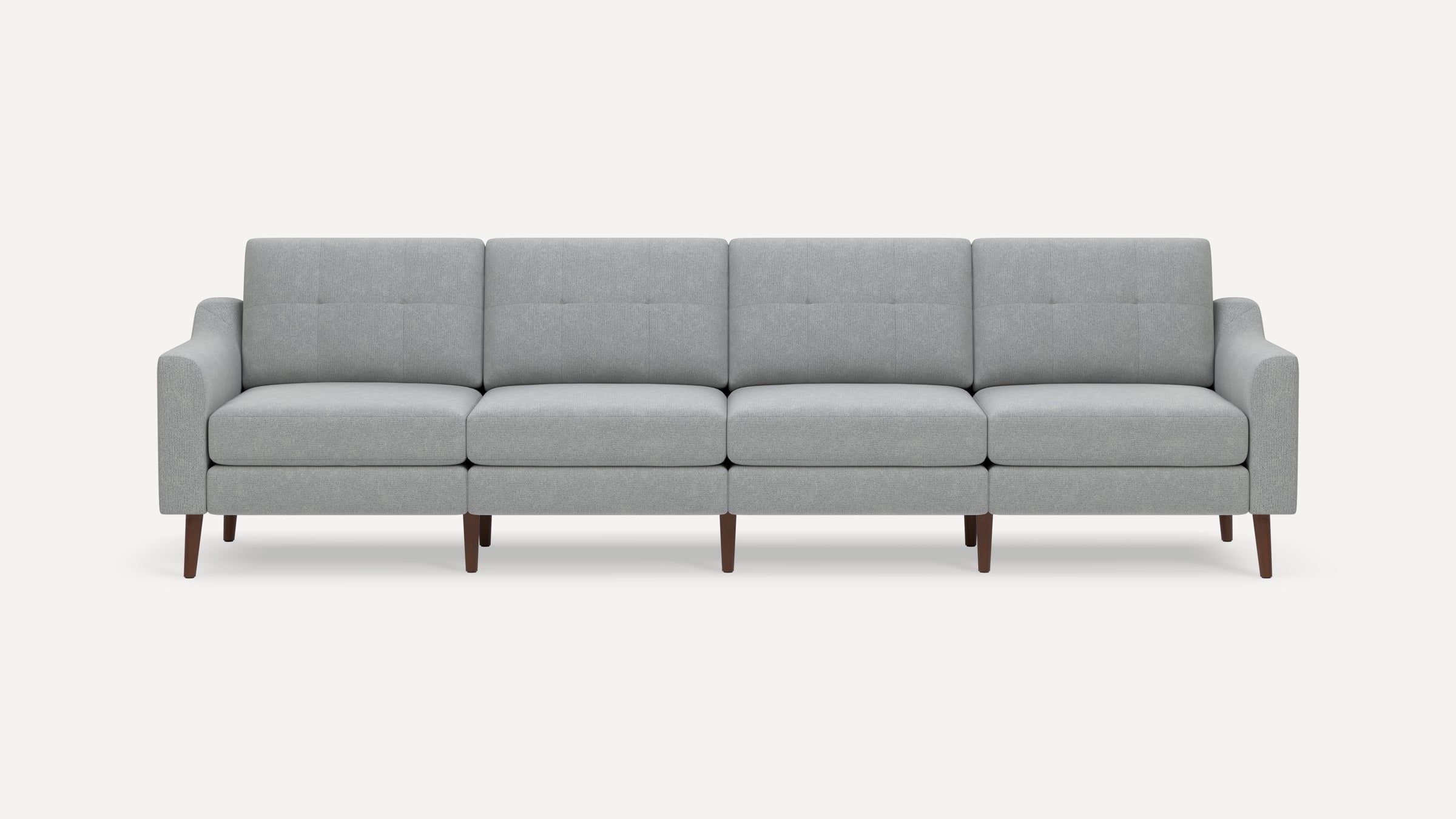 Modern light gray fabric sofa with four cushioned seats, square button-tufted backs, and wooden tapered legs.