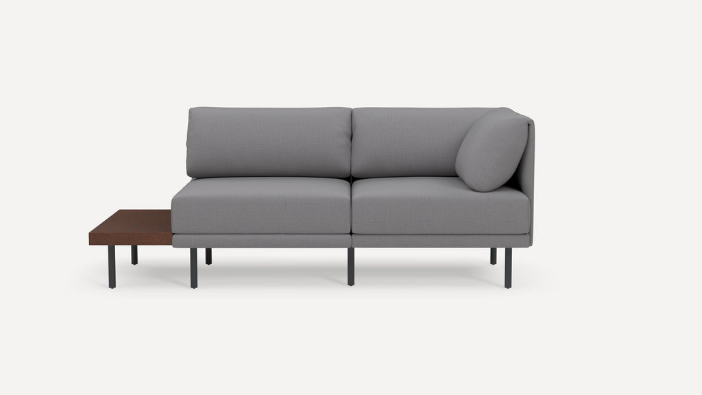 Modern gray sectional sofa with metal legs and attached wooden side table, featuring clean lines and a minimalist design.
