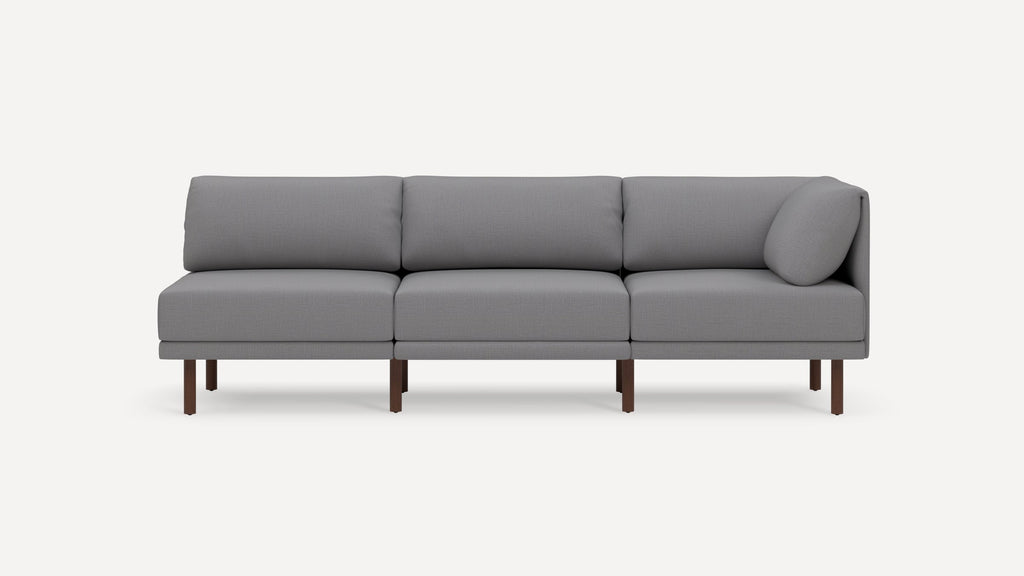 Modern gray fabric sectional sofa with wooden legs, featuring three seating cushions and a simple, clean design.