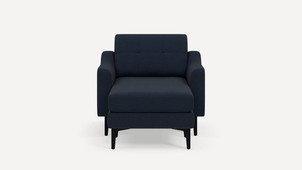 Modern dark navy blue armchair with matching cushioned ottoman, straight armrests, and black wooden legs on white background.
