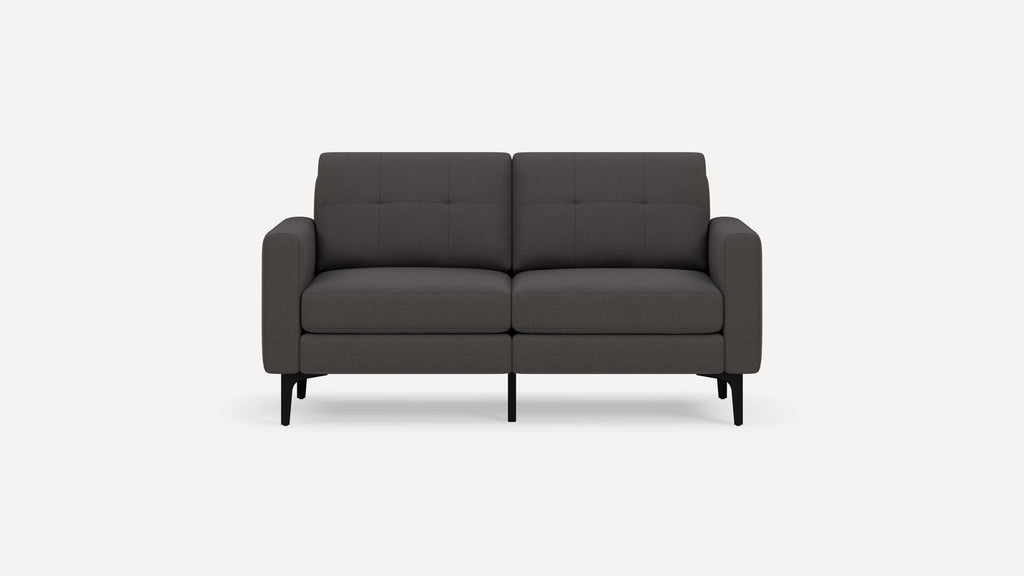 Two-seater modern dark gray fabric sofa with black metal legs and tufted back cushions, shown against a white background.