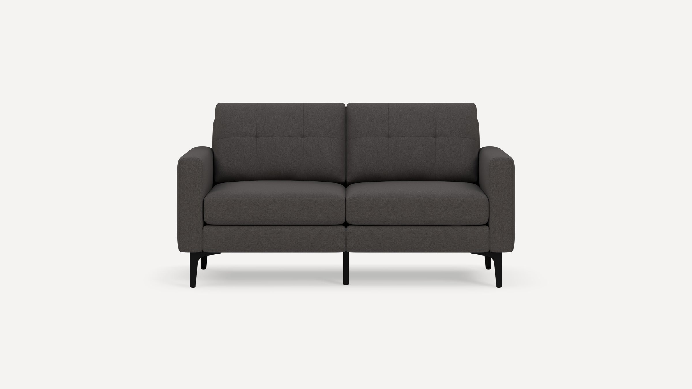 Two-seater modern dark gray fabric sofa with black metal legs and tufted back cushions, shown against a white background.