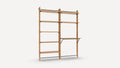 Wooden wall-mounted shelving unit with multiple open shelves and a built-in desk supported by metal brackets.