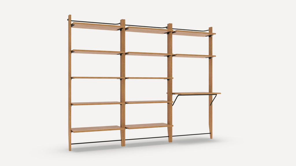 Wooden modular wall-mounted shelving unit with three vertical supports, multiple horizontal shelves, and one fold-down work surface supported by metal brackets.