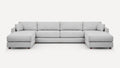 Light grey fabric sectional sofa with one chaise on each end and wooden legs, featuring plush back and side cushions.