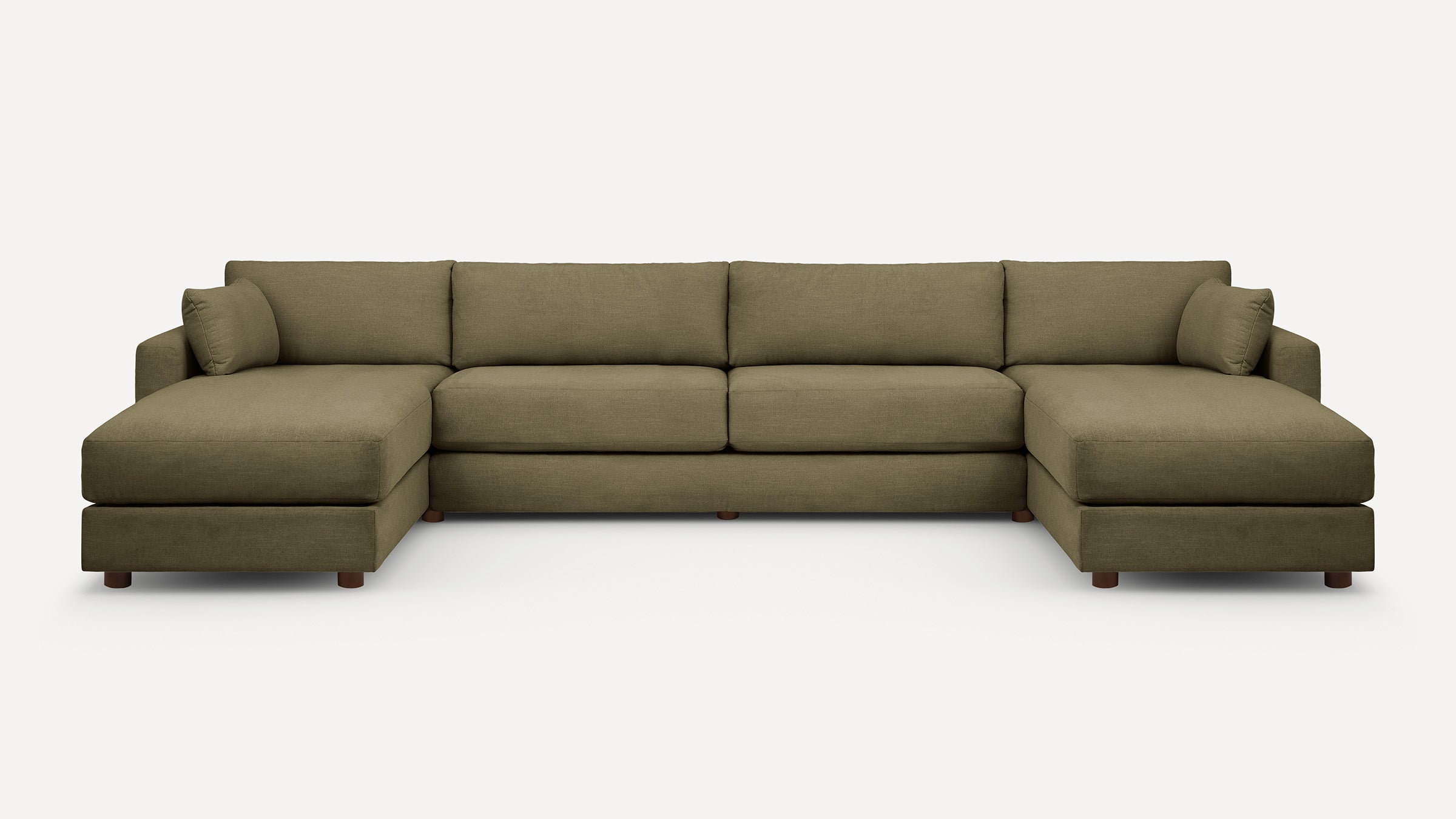 Large olive green fabric sectional sofa with two chaise lounges and matching cushions, supported by short wooden legs.