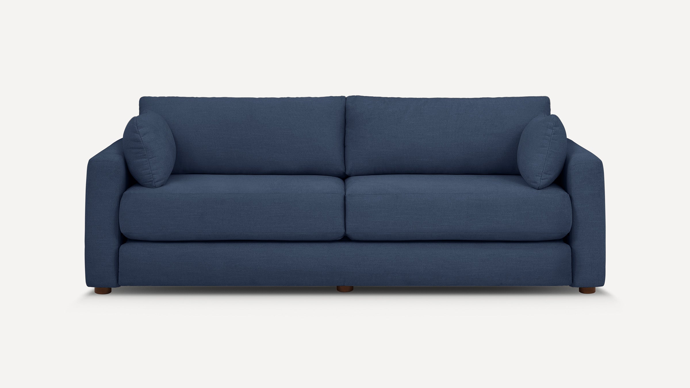 Modern navy blue fabric sofa with two seat cushions, two back cushions, and rounded armrests on wooden legs.