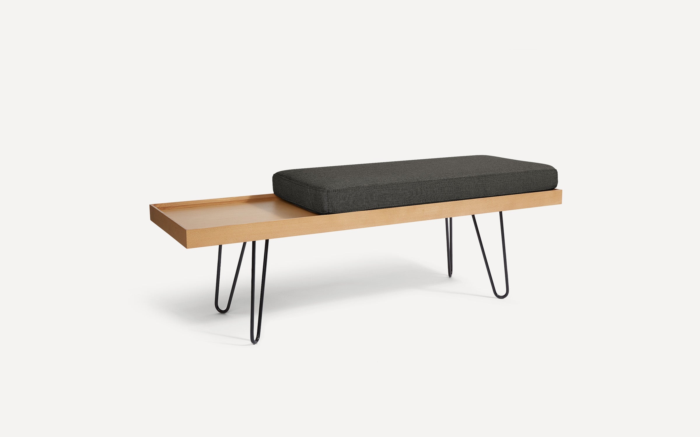 modern wooden bench with black cushion and hairpinned legs on white background